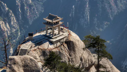 HD desktop wallpaper of a religious temple perched atop Mount Hua in China, showcasing the dramatic cliffs and serene natural beauty.