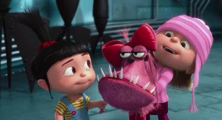 HD desktop wallpaper featuring Agnes and Edith from Despicable Me, with Agnes smiling and Edith holding a pink, fang-toothed plush toy with a big red bow.