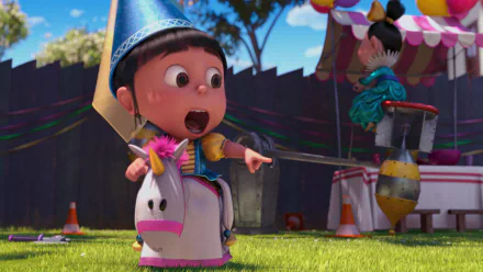 Agnes from Despicable Me 2 joyfully points while riding a unicorn toy, wearing a party hat in a festive outdoor setting, captured in vibrant HD for a lively desktop wallpaper.