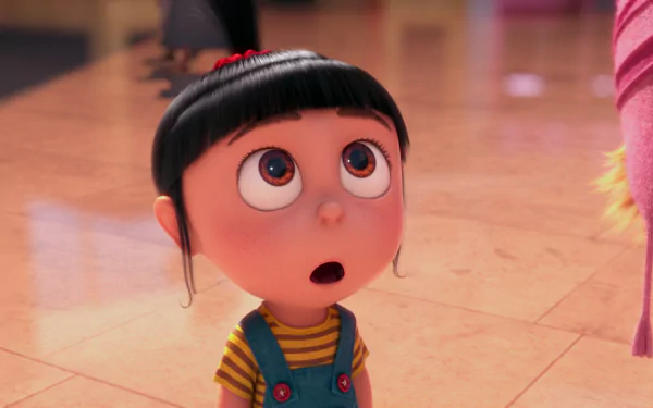 Agnes from Despicable Me looks up with wide eyes, showcasing her playful curiosity. This HD wallpaper captures a moment from Despicable Me 2, full of charm and wonder.