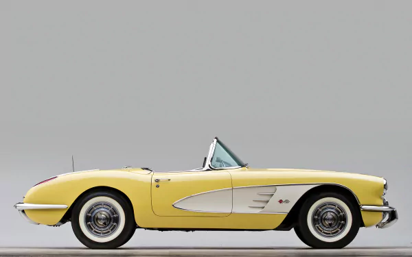 Side-profile of a yellow Chevrolet Corvette (C1) convertible on a neutral background — HD PC desktop wallpaper and background showcasing the classic Chevrolet vehicle.