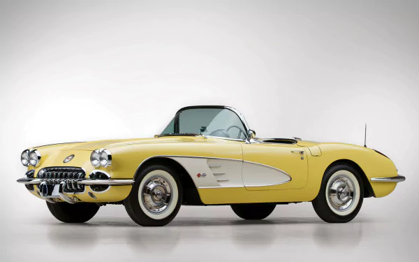 HD PC desktop wallpaper featuring a classic yellow Chevrolet Corvette (C1) vehicle against a plain white background.