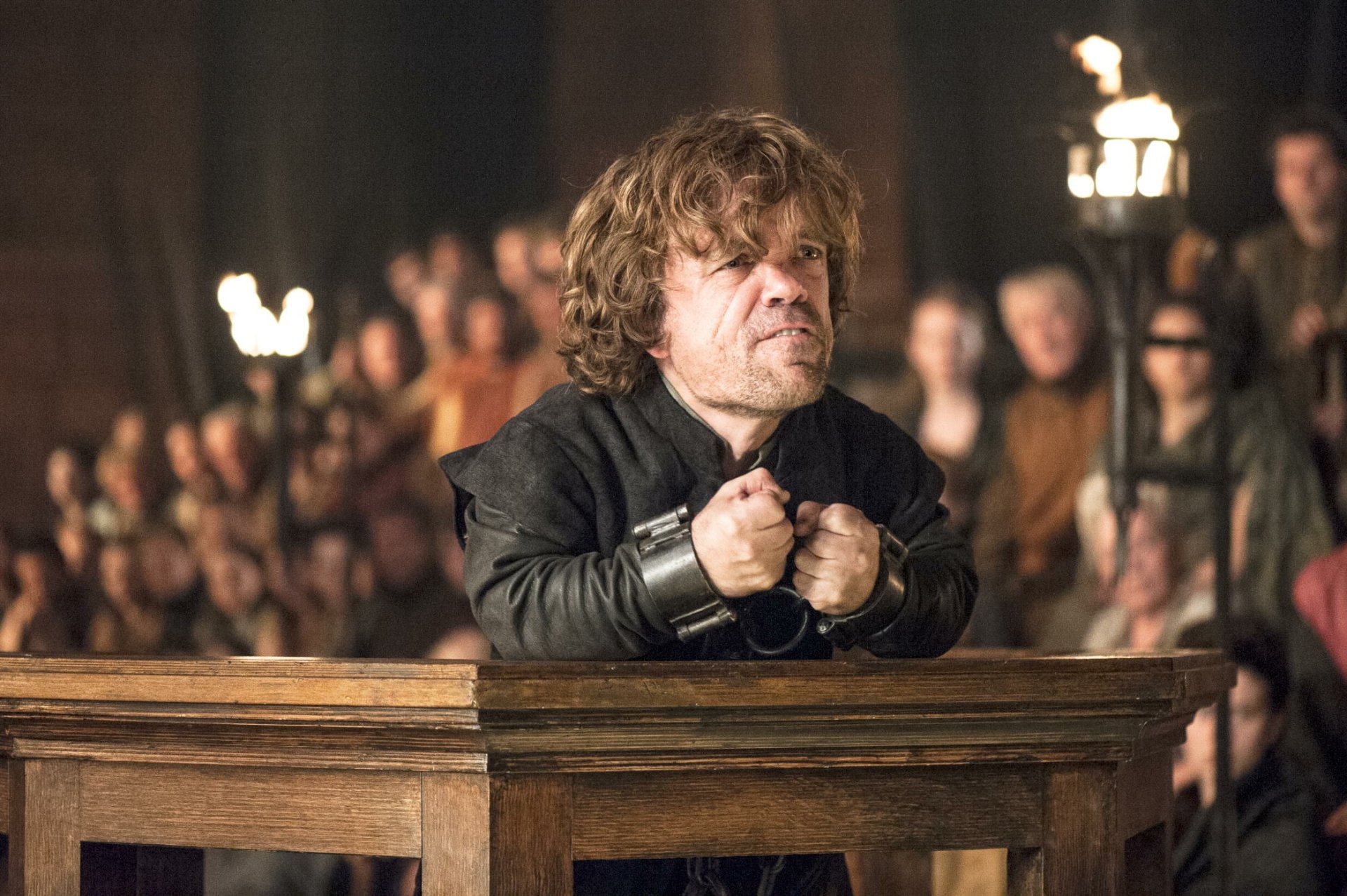 Peter Dinklage portrays Tyrion Lannister in a tense courtroom scene from the TV show Game of Thrones, captured in this HD desktop wallpaper.
