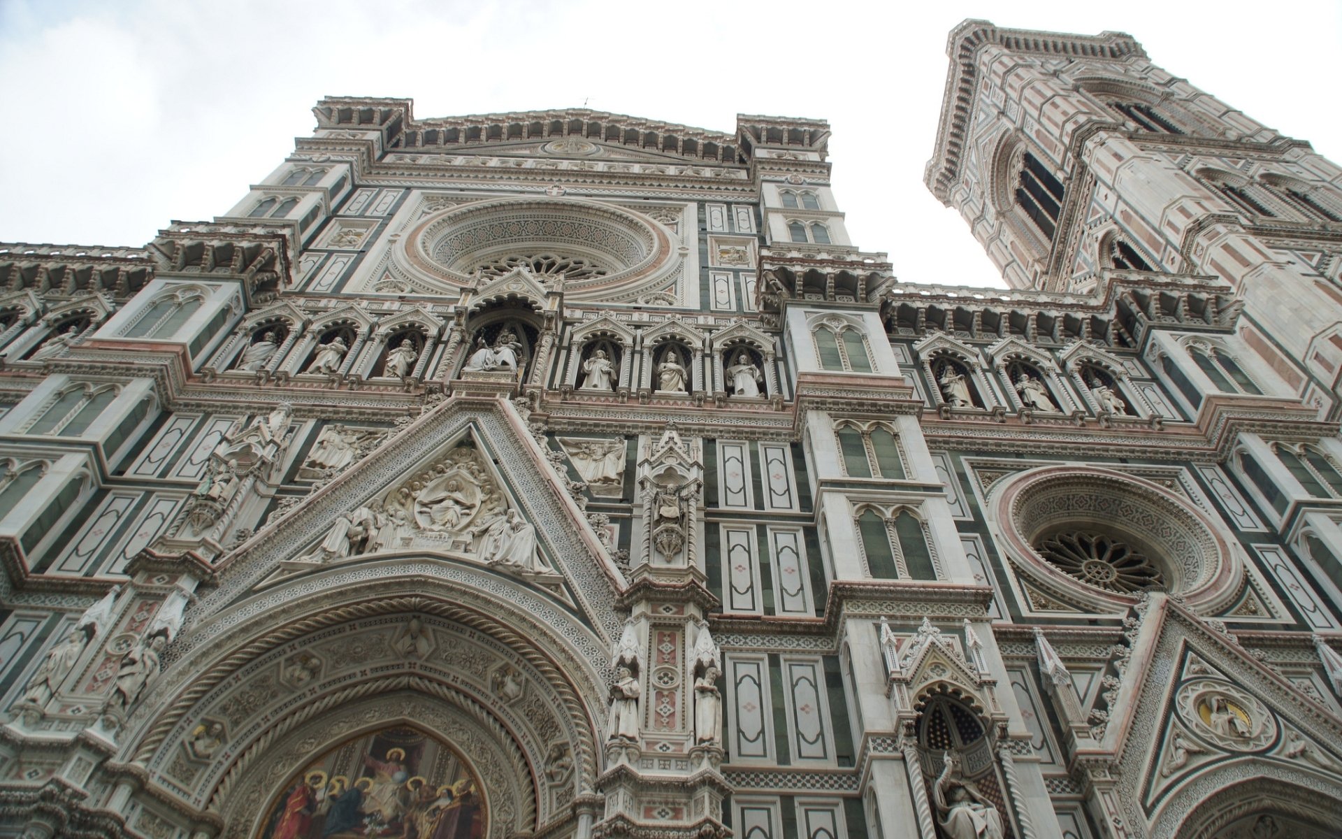 HD PC desktop wallpaper: low-angle view of the religious Basilica of Saint Mary of the Flower's ornate marble facade and bell tower, showcasing intricate Gothic‑Renaissance details.