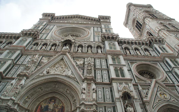 HD PC desktop wallpaper: low-angle view of the religious Basilica of Saint Mary of the Flower's ornate marble facade and bell tower, showcasing intricate Gothic‑Renaissance details.