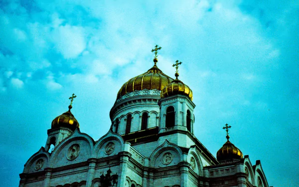 HD PC desktop wallpaper of the Cathedral of Christ the Saviour: golden domes and crosses rising above a white facade against a vivid turquoise sky.