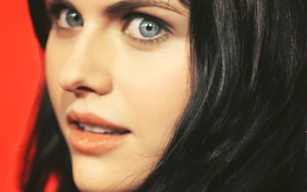 A striking HD desktop wallpaper featuring actress Alexandra Daddario, showcasing her captivating blue eyes and alluring expression against a vibrant backdrop.