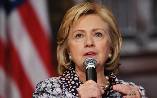 HD desktop wallpaper of a woman speaking into a microphone with an American flag in the background.