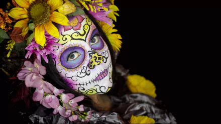 Artistic close-up of a person with a vibrant sugar skull face paint adorned with colorful flowers, captured in stunning 4K Ultra HD for PC desktop wallpaper.