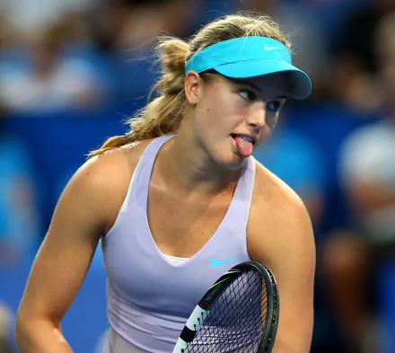 HD desktop wallpaper featuring Eugenie Bouchard in action during a tennis match, showcasing her focus and athleticism in the sports arena.