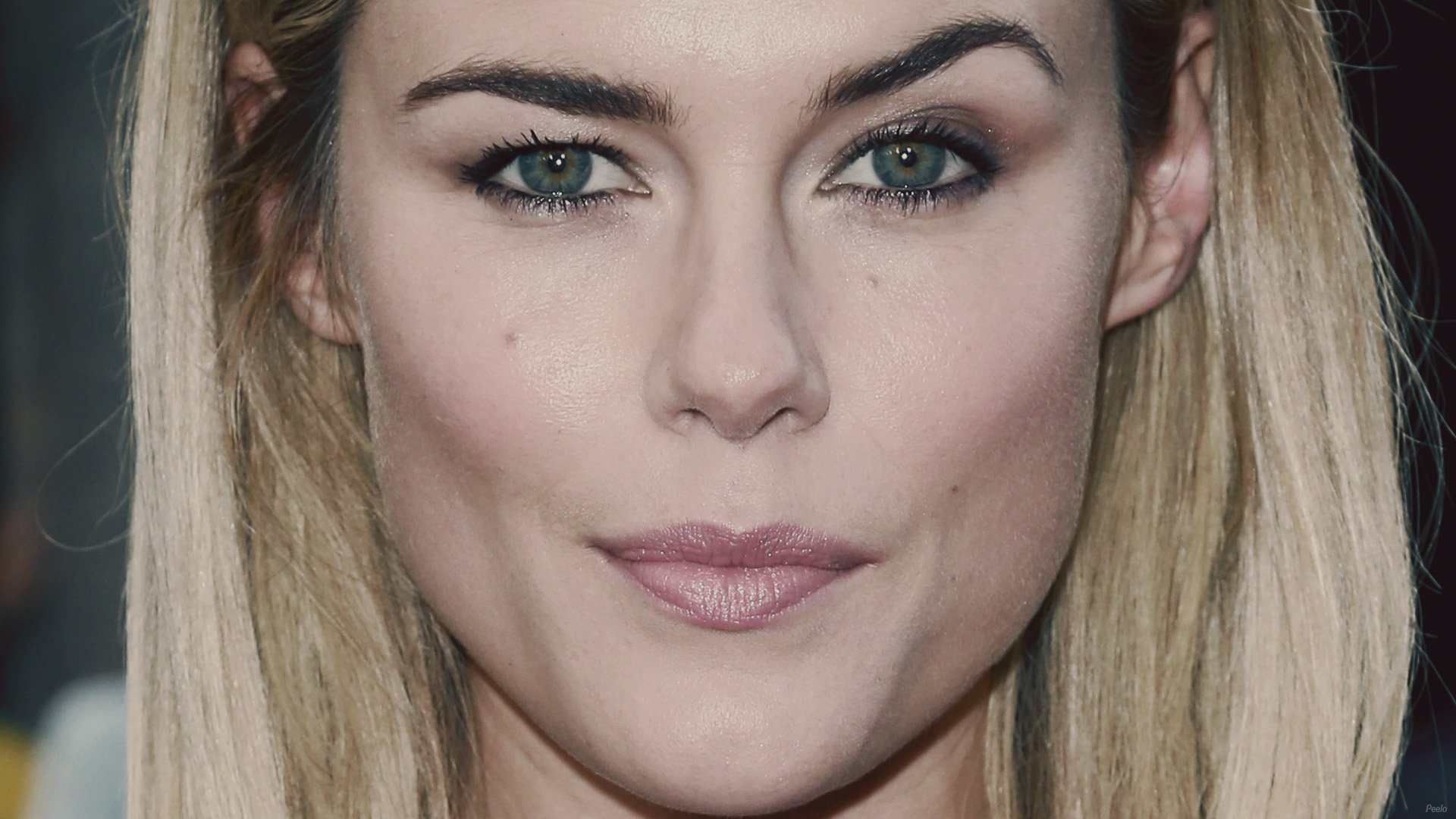 Close-up HD desktop wallpaper of celebrity Rachael Taylor with blonde hair and green eyes, showcasing her natural makeup and confident expression.