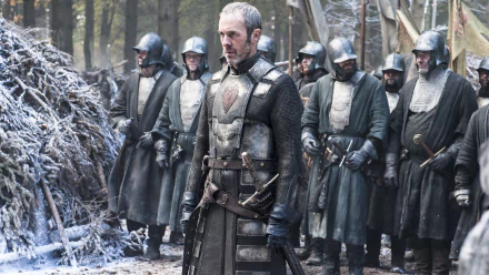 Stannis Baratheon, portrayed by Stephen Dillane, stands confidently in a wintry forest, flanked by armored soldiers, from the TV show Game of Thrones. A striking 4K Ultra HD wallpaper.