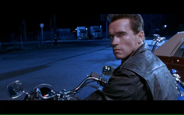 Arnold Schwarzenegger as the Terminator in a scene from Terminator 2: Judgment Day, showcasing his iconic look while riding a motorcycle at night.