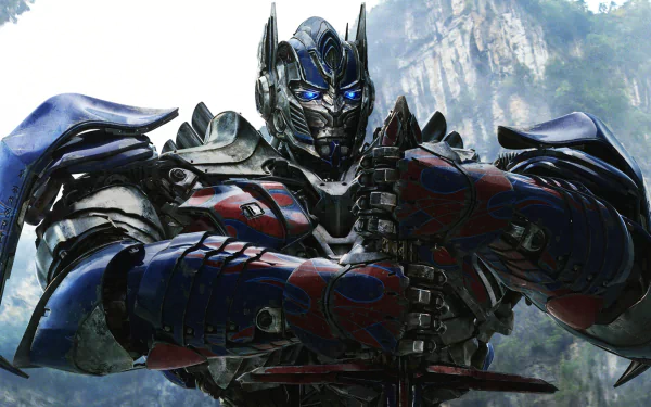 HD wallpaper featuring Optimus Prime from Transformers: Age of Extinction, posed dramatically with a mountainous backdrop.