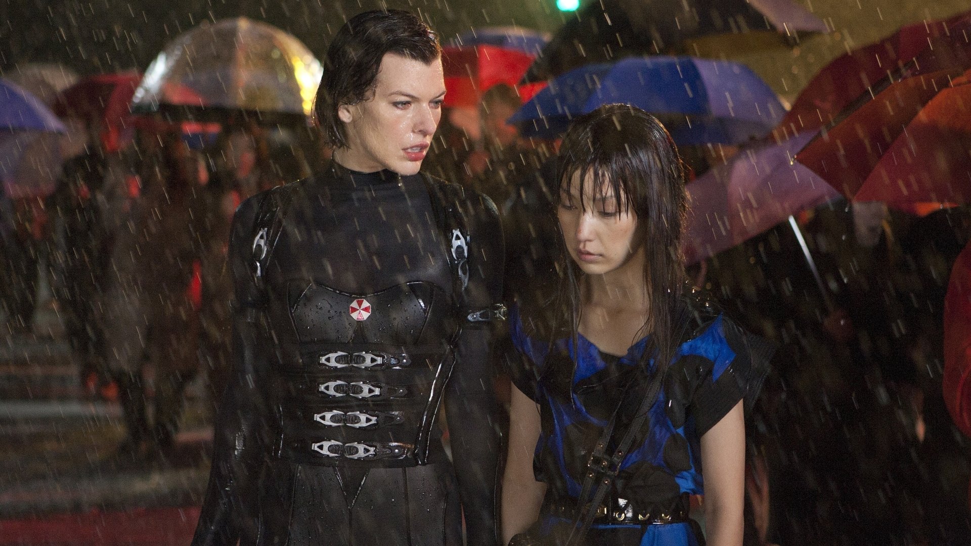 HD desktop wallpaper featuring characters from the movie Resident Evil: Retribution standing in the rain with colorful umbrellas in the background.