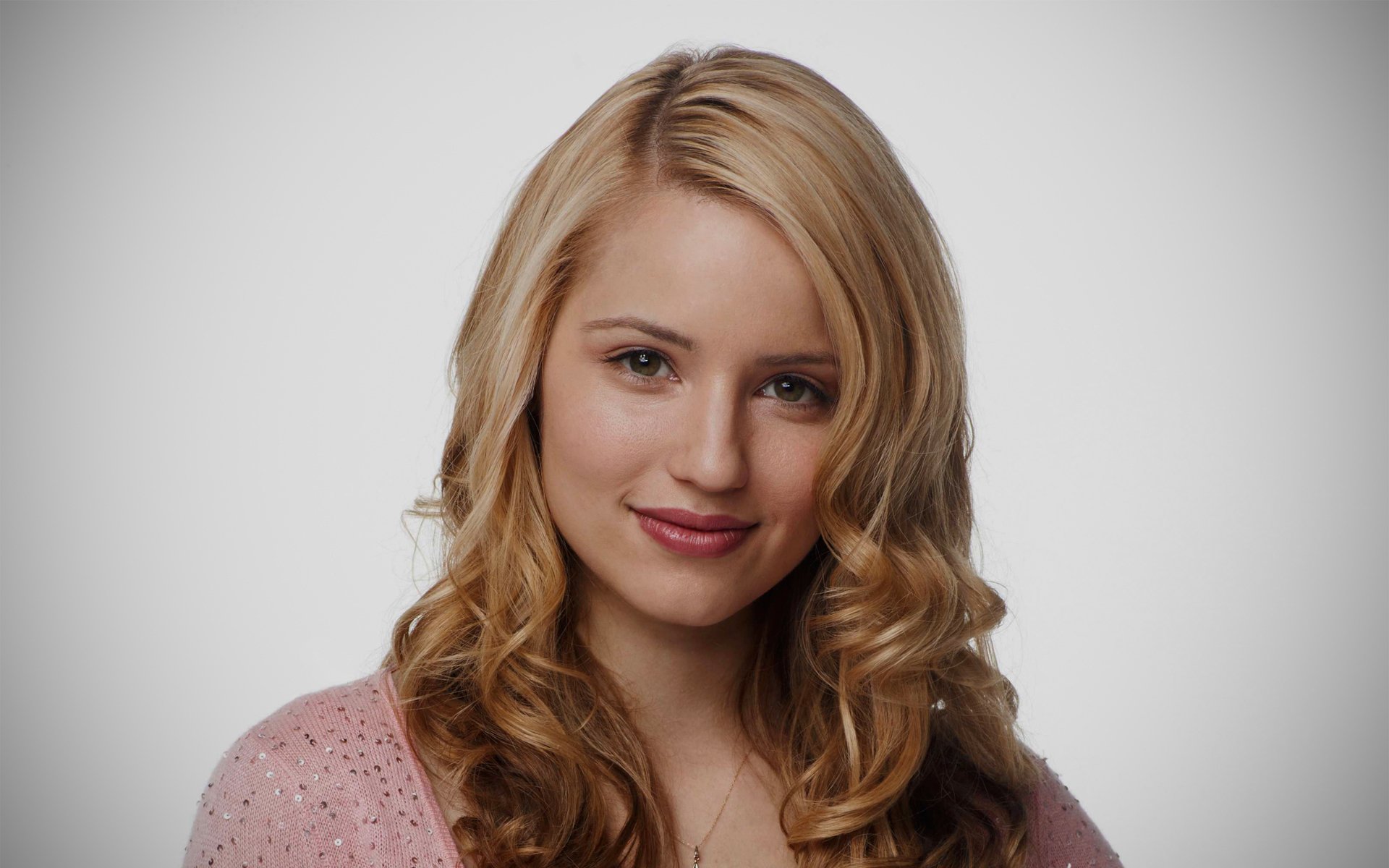 HD desktop wallpaper featuring American actress and celebrity Dianna Agron with soft curls and a gentle smile against a neutral background.