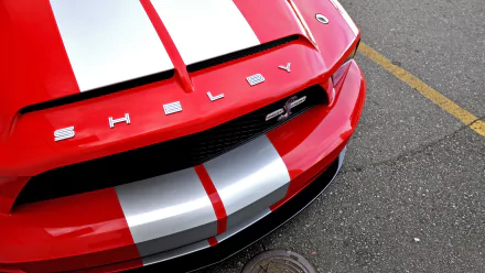 Close-up HD desktop wallpaper of a red Ford Mustang Shelby Cobra GT 500 with white racing stripes.
