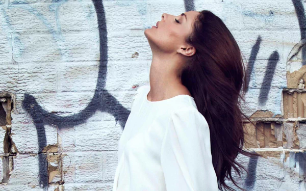 HD desktop wallpaper featuring Olivia Palermo in a white outfit against a graffitied wall background.
