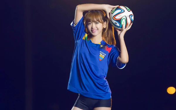 HD desktop wallpaper of an Asian woman in an Ecuador soccer jersey holding a soccer ball against a dark background.
