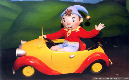 HD desktop wallpaper featuring Noddy, the cheerful character from the TV show, driving his iconic yellow and red car against a green hilly background.