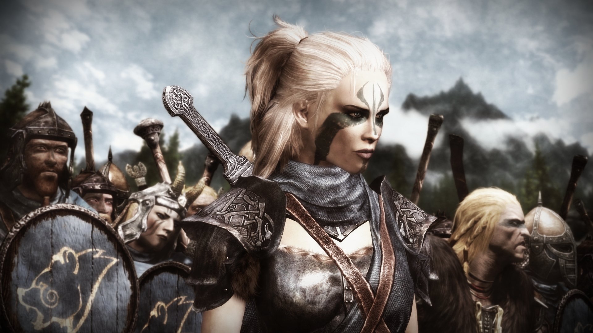 A high-definition wallpaper from The Elder Scrolls V: Skyrim, featuring a fierce warrior woman in armor, poised for battle, with a backdrop of soldiers ready to march.