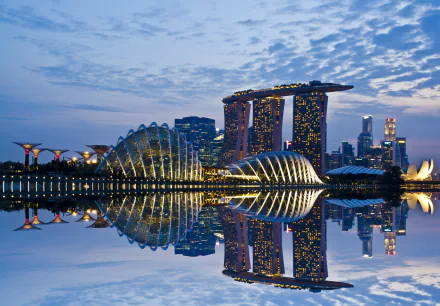 HD desktop wallpaper showcasing Singapore’s Marina Bay Sands and Gardens by the Bay at dusk with a clear reflection on the water.