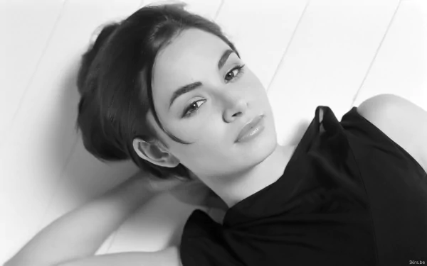 Black-and-white HD desktop wallpaper featuring celebrity Mía Maestro reclining with a calm, confident expression.