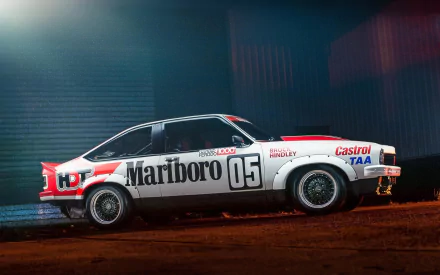 HD PC desktop wallpaper featuring a classic race car with Marlboro and Castrol branding, captured in a moody, dimly lit setting.