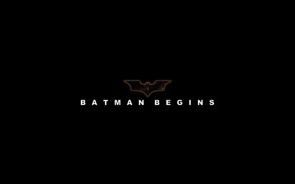 HD desktop wallpaper featuring the Batman Begins logo and title on a black background.