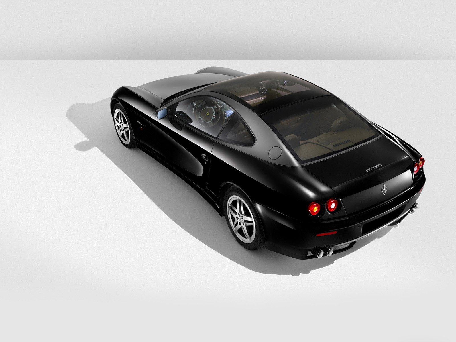 A sleek black Ferrari 612 Scaglietti captured in high definition, presented as a stylish PC desktop wallpaper background.