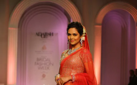 Esha Gupta, the Indian actress and celebrity, confidently showcases traditional elegance in this HD desktop wallpaper, captured during a bridal fashion event.