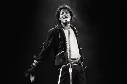 A dynamic black and white image of Michael Jackson performing, capturing his energy and iconic style, suitable as a HD PC desktop wallpaper and background celebrating music.