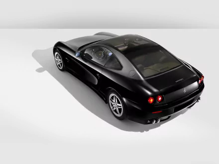 A sleek black Ferrari 612 Scaglietti captured in high definition, presented as a stylish PC desktop wallpaper background.