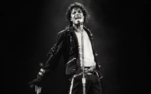 A dynamic black and white image of Michael Jackson performing, capturing his energy and iconic style, suitable as a HD PC desktop wallpaper and background celebrating music.