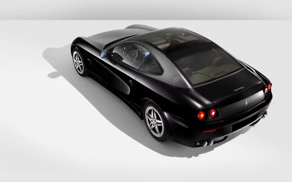 A sleek black Ferrari 612 Scaglietti captured in high definition, presented as a stylish PC desktop wallpaper background.