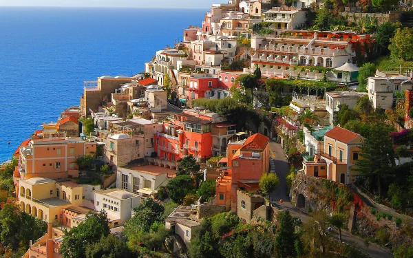 HD wallpaper of the colorful cliffside village of Positano in Salerno, Italy, overlooking the deep blue sea.