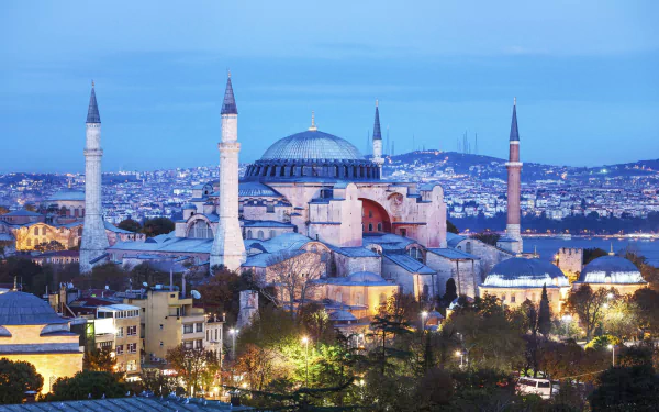 A stunning HD wallpaper of Hagia Sophia at dusk, showcasing its iconic architecture and minarets against a vibrant skyline, encapsulating its religious and historical significance.