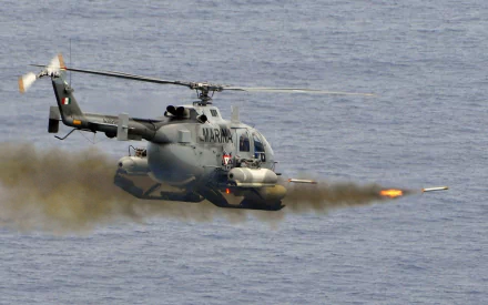 Military MBB Bo 105 in HD PC desktop wallpaper and background: helicopter firing rockets over open ocean at low altitude.