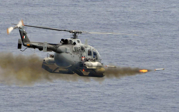 Military MBB Bo 105 in HD PC desktop wallpaper and background: helicopter firing rockets over open ocean at low altitude.