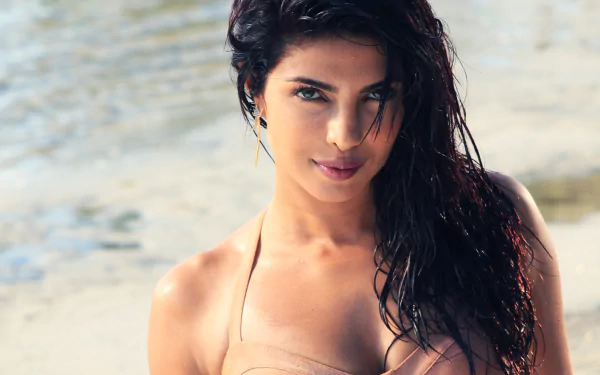 A stunning HD wallpaper featuring Indian celebrity Priyanka Chopra, capturing her in a beach setting with wet, wavy hair and a captivating expression.