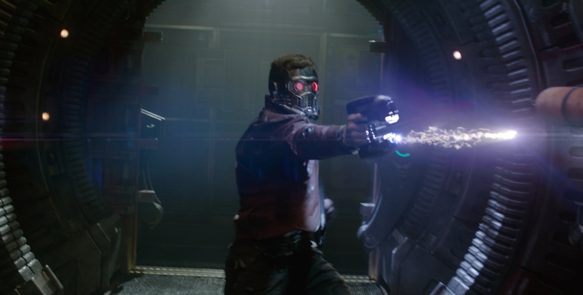 HD PC desktop wallpaper featuring Chris Pratt as Peter Quill from the movie Guardians of the Galaxy, aiming and firing a futuristic weapon inside a spaceship.