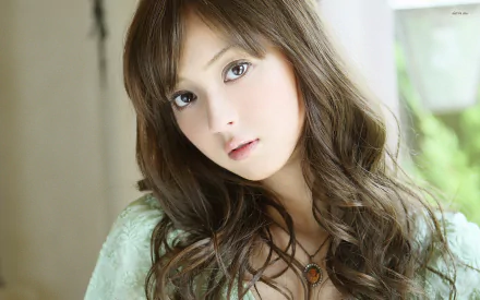HD desktop wallpaper featuring a close-up portrait of celebrity Nozomi Sasaki with soft lighting and a natural background.