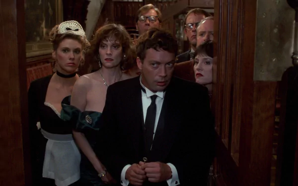 HD PC desktop wallpaper showing a tense group of formally dressed characters crowded in a dim manor hallway from the movie Clue.