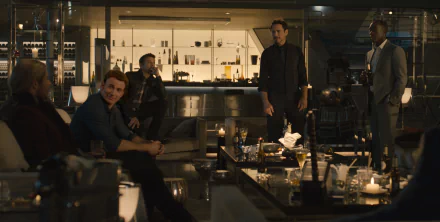 A scene from *Avengers: Age of Ultron* featuring Chris Evans, Jeremy Renner, Robert Downey Jr., and Don Cheadle in a stylish setting, surrounded by drinks and candles.