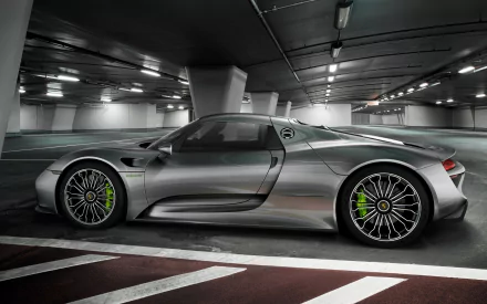 HD PC desktop wallpaper featuring a sleek silver Porsche 918 Spyder parked in a modern underground garage with dramatic lighting.