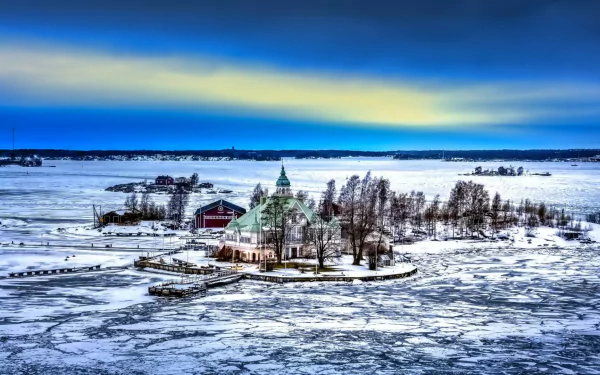 HD PC desktop wallpaper: a man-made villa on a tiny snowy island, surrounded by cracked sea ice beneath a dramatic blue and yellow dawn sky.