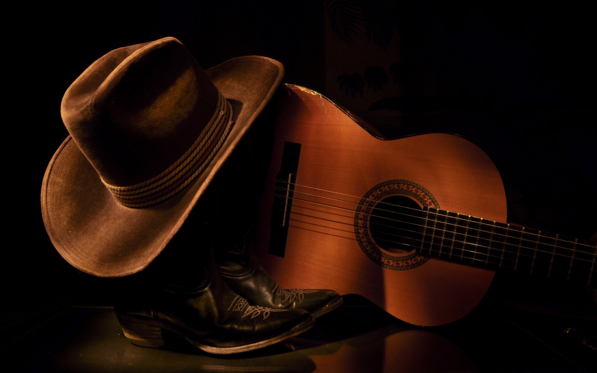 HD PC desktop wallpaper featuring a guitar, cowboy hat, and boots against a dark background, highlighting music and rustic Western themes.