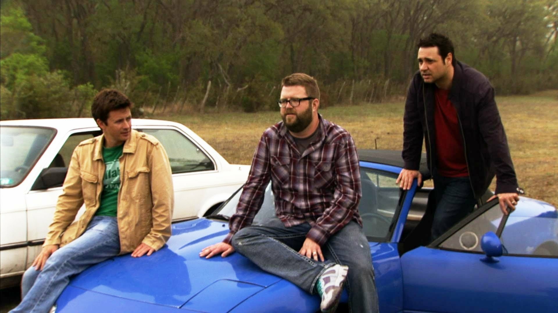 HD desktop wallpaper featuring three presenters from Top Gear with a car, against a natural backdrop.