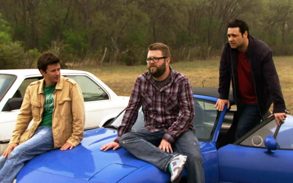 HD desktop wallpaper featuring three presenters from Top Gear with a car, against a natural backdrop.