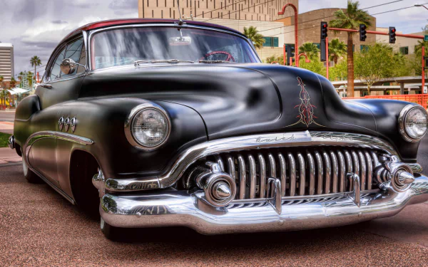 A striking vintage Buick captures attention with its sleek black body and chrome details, showcased in HDR quality. This retro vehicle serves as a captivating desktop wallpaper.